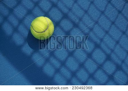Tennis Ball In The Court With Net Shadow On It