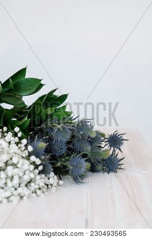 Blue Flowers Eringium And Gypsophila  On A Close-up Table