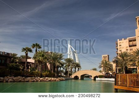 DUBAI, UAE - FEBRUARY, 2018: View on Burj Al Arab, the world only seven stars hotel seen from Madinat Jumeirah, a luxury resort which include hotels and souk spreding across over 40 hectars.