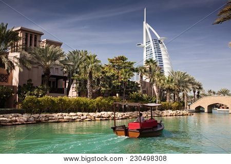 DUBAI, UAE - FEBRUARY, 2018: View on Burj Al Arab, the world only seven stars hotel seen from Madinat Jumeirah, a luxury resort which include hotels and souk spreding across over 40 hectars.