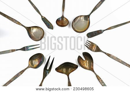 Old Silver Cutlery Arranged In A Circle Isolated On White Background
