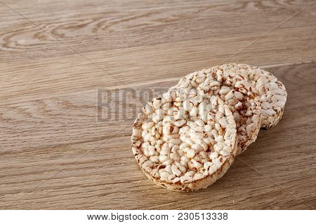 Stack Of Diet Crispbreads On Light Wooden Table, Close-up, Selective Focus. Composition Of Puffed Ri