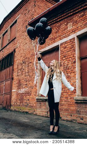 Beautiful Girl In Autumn Garden In A White Coat