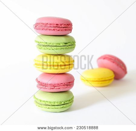 Three Different Types Of Macaroons Colors Pink, Green And Yellow Isolated On White Background. Close