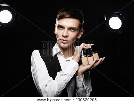  Young male make up artist posing  with foundation for make-up o