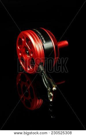 Brushless Motor With Wires Isolated On The Black Reflective Background