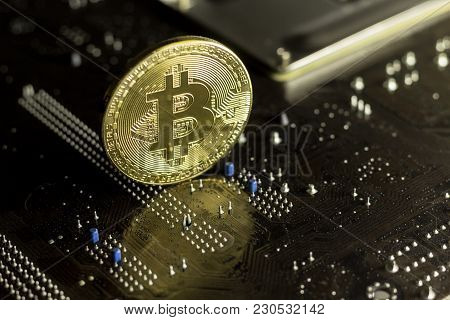 Bitcoin Coin On The Back Of A Pc Motherboard, Symbolizing It's A Virtual Money.
