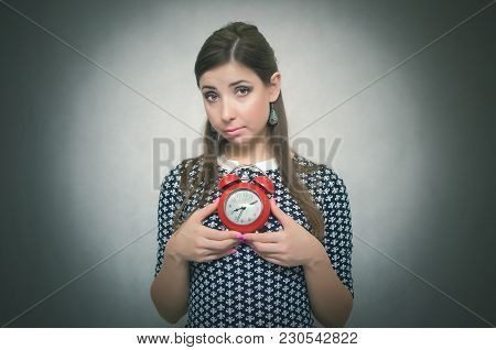 Guilty Look Woman Holding In Hands Alarm Clock And Hides Her Eyes. Latecomer Student Or Emloyee. Be 