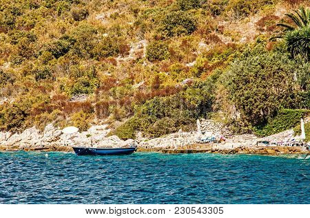 Sea Shore With Little Boat In Maslinica, Solta Island, Croatia. Summer Vacation Destination. Yellow 