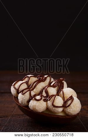 Chocolate Egg Ith Filling For Easter On Wooden Background