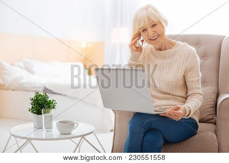Progressive Pensioner. Smart Positive Excited Pensioner Feeling Happy While Sitting In A Nice Comfor