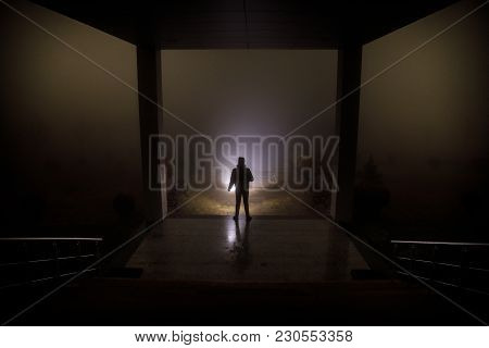 Creepy Silhouette In The Dark Abandoned Building. Dark Corridor With Cabinet Doors And Lights With S