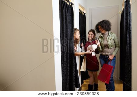 Beautiful Young Woman Asking For A Friends Opinion In The Fitting Room Of Lingerie Store. Female Tri