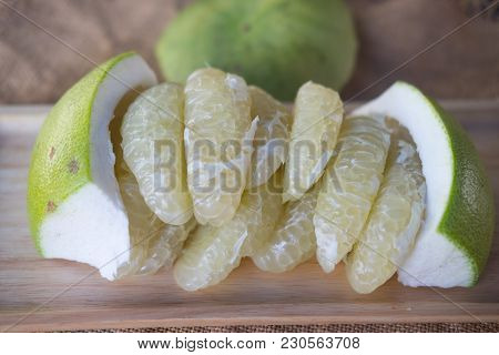 Citrus Sweetie Or Pomelit Fruit On Wooden Tray