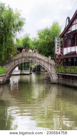 July 5, 2015.  Shanghai, China.  Chinese Tourists On The Many Bridges Over The Water Canals Of Zhaoj