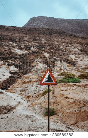 Warning Road Sign, Beware Of Falling Rocks.