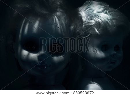 Two Closeup Creepy Faces Of Scary Cracked Dolls Without Eyes.