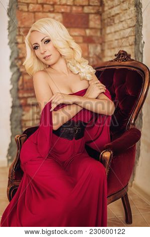 Portrait Of Beautiful Young Woman In Red Dress With Makeup In Fashion Clothes