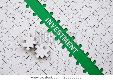 Investment. The Green Path Is Laid On The Platform Of A White Folded Jigsaw Puzzle. The Missing Elem