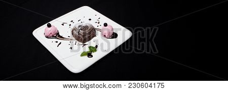 Dessert Fondan Chocolate With Ice-cream On A White Plate On A Black Background. Exquisite French Cho