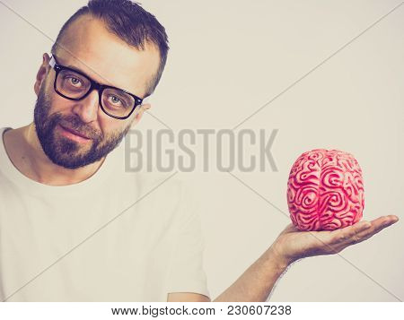 Adult Nerd Man Wearing Eyeglasses Looking At Human Brain Model. Thinking And Intelligence Conept