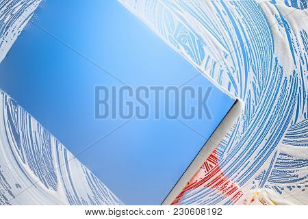 Cleaning Window With Squeegee Blue Sky. Studio Shot