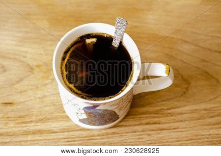 Coffee With Lemon In A White Cup With A Beautiful Pattern On A Natural Wooden Board