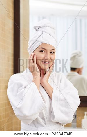 Smling Young Woman In Bathrobw With Towel On Her Head