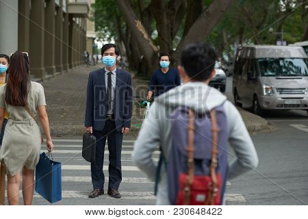 Asian Businessman In Face Mask Crossing Road