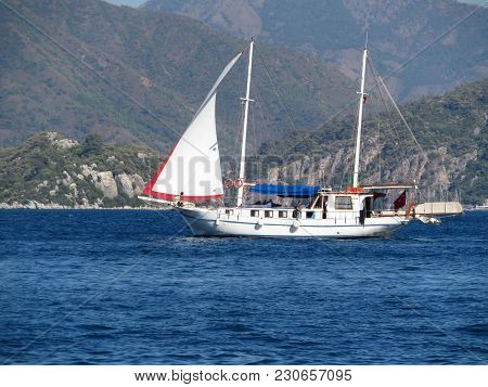 Sailing Boat On A Background Of Mountains In The Aegean Sea