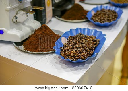 Ground Coffee And Roasted Coffee Beans Arabica Strong Blend In Blue Plastic Dish.