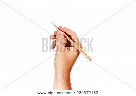A Man's Hand Holds An Orange Pencil On A White Background, Isolate.