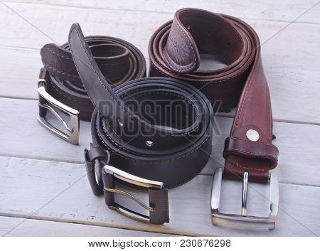 Fashionable Men's Leather Belt. Gadgets And Accessories For Men On Light Wooden Background.