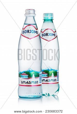 London, Uk - March 10, 2018 : Glass And Plastic Bottle Of Borjomi Sparkling Mineral Water On White B