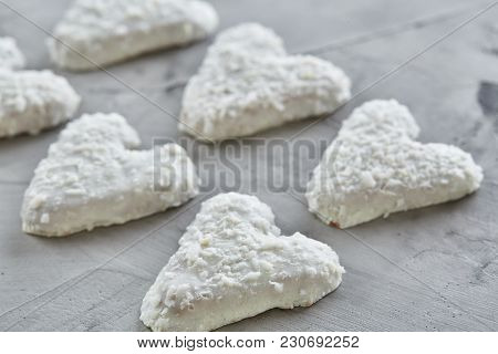 Sweet Crunchy Coconat Heart-shaped Biscuits Arranged In Pattern On Light Textured Background, Top Vi