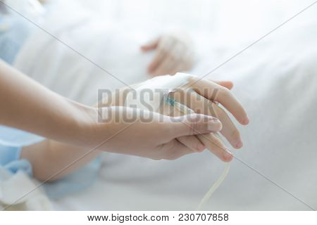 Woman Holding Children Hand In Hospital. Girl Sick In Hospital. People With Medical Concept.