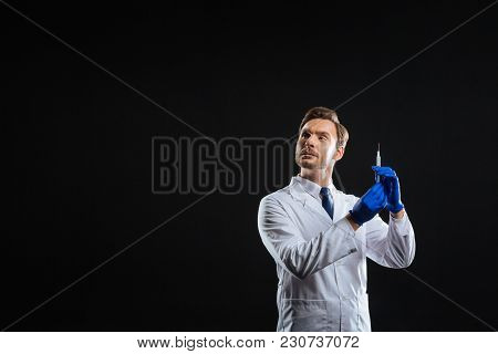 Im Busy. Occupied Skilled Baerdful Medic Being Alone In The Spacious Room Looking Aside And Holding 