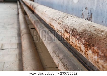 Rusty Water Pipe Factory Pipe Along The Wall