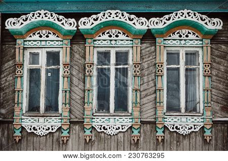 Three Windows With White Decorative Wood Carving Frame. Russian Folk Style. Front View Close Up.