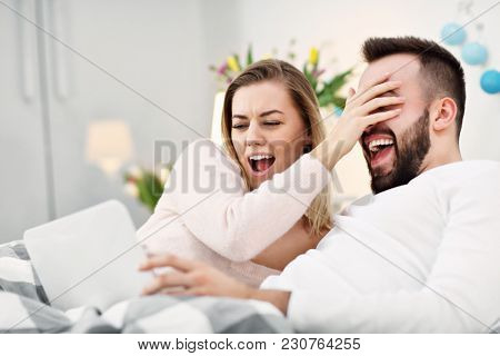 Couple in bed watching TV