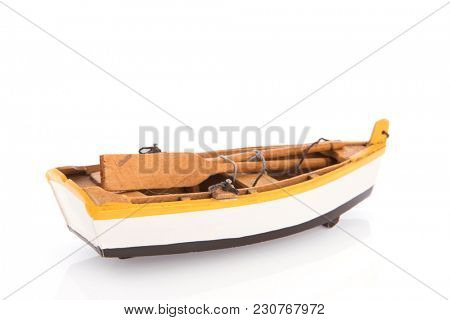 Wooden rowing boat with oars isolated over white background