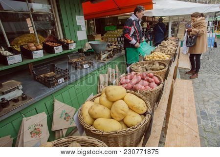 Munich, Germany - November 16, 2017: Local Farmer Selling Potato And Other Vegetables At City Market