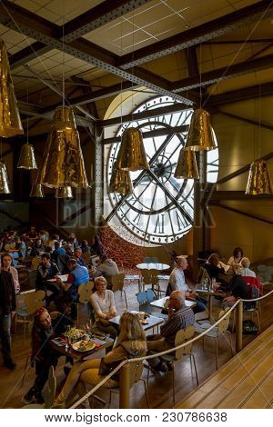 Paris, France, March 28 2017: Giant clock of Musee dOrsay with unidentified people. It houses in the former Gare d'Orsay, a Beaux-Arts railway station. It is one of the largest museums in Europe