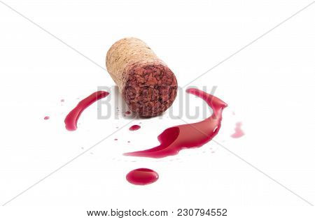 Wine Cork With Drops Of Red Wine Isolated On White Background
