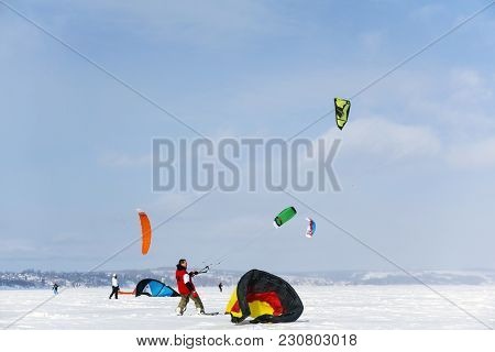 Perm, Russia - March 09, 2018: Snowkiters Rides On The Ice Of A Frozen River