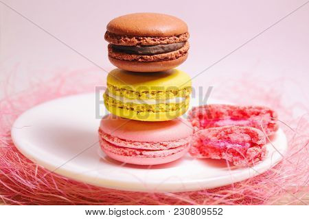 Brown, Yellow And Pink Macaroons Stack Of Pastel Colors Standing On A Small White Plate And Pink Dec