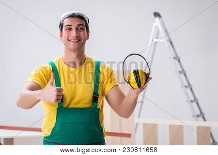 Worker showing the importnace of wearing noise cancelling headph