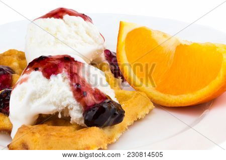 Plate Of Belgian Waffles With Ice Cream, Jam And A Slice Of Orange On White Background.
