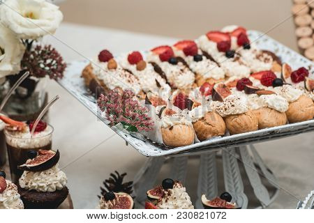Candybar In A Restaurant. Decorated White Table Fool Of Sweet Pastry. Wedding Sweets.