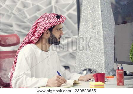 Arabian Business Man Working On Laptop In The Office.